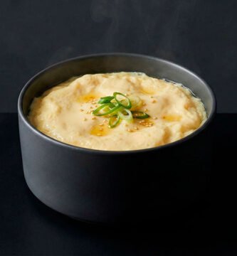 Gyeran-jjim is a classic Korean steamed egg dish known for its silky texture and comforting warmth, presented in a refined editorial style.